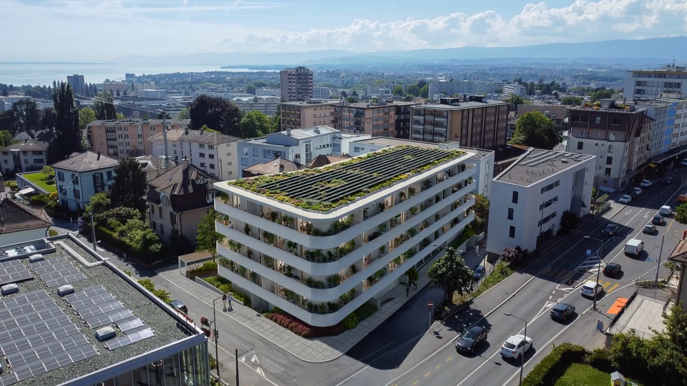 HIATUS — la résidence à Prilly depuis le ciel, le Léman et les Alpes derrière.